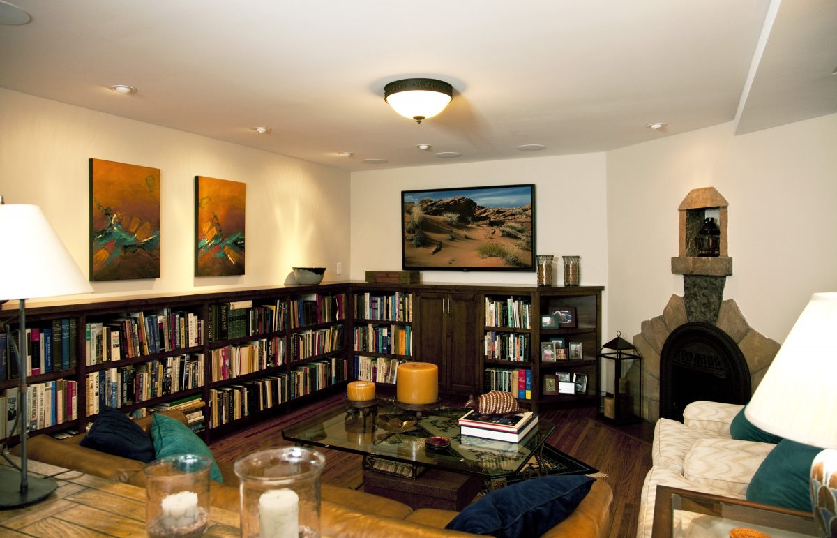<p>Prior to being remodeled, this basement was used as storage. TreHus refinished the hardwood floors and added built-in alder cabinets, a new entertainment area, improved lighting and in-ceiling speakers.</p>
