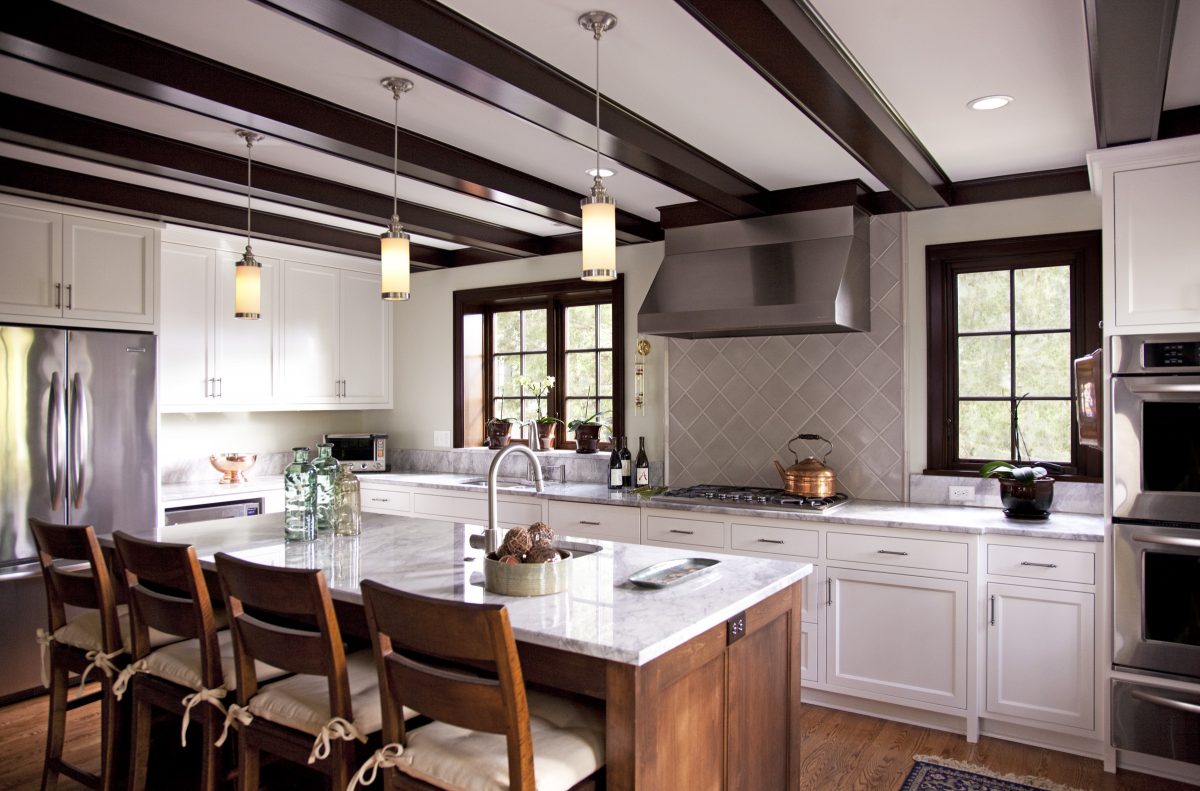 <p>Built in 1930, this classic Tudor home looks fresh and clean after its recent renovation. The kitchen includes custom cabinetry, a beamed ceiling, a coffee station, built-in cookbook storage and a message center. Large windows and an eating area add to the light, welcoming feeling of the space.</p>
