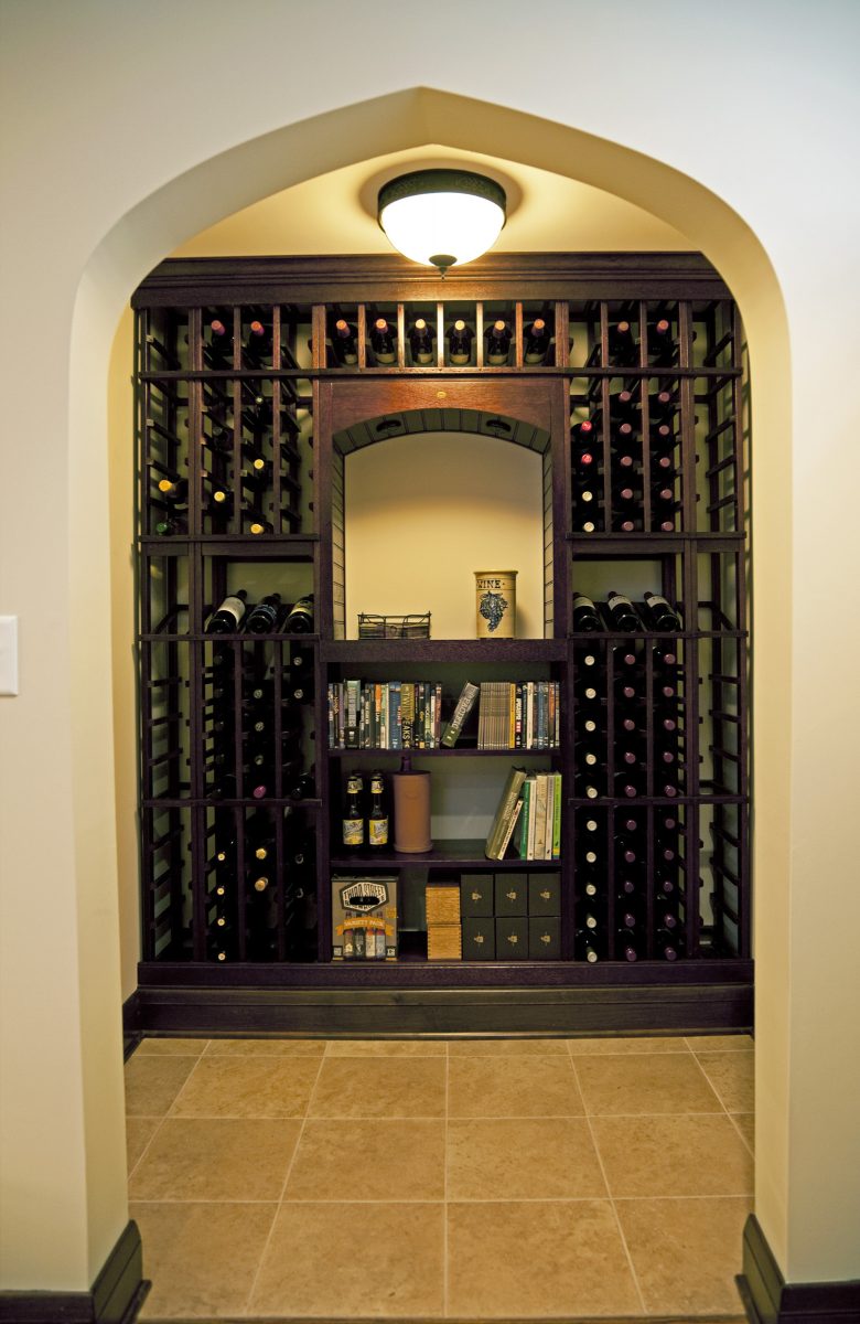<p>This little wine nook used to be a storage closet. Opening up the entryway connected it to the rest of the newly remodeled basement, then it was just a matter of adding lighting, tile, millwork and shelves for wine storage. It has a 140 bottle capacity, plus a shelf for tasting and storage for books, beer or extra cases of wine.</p>
