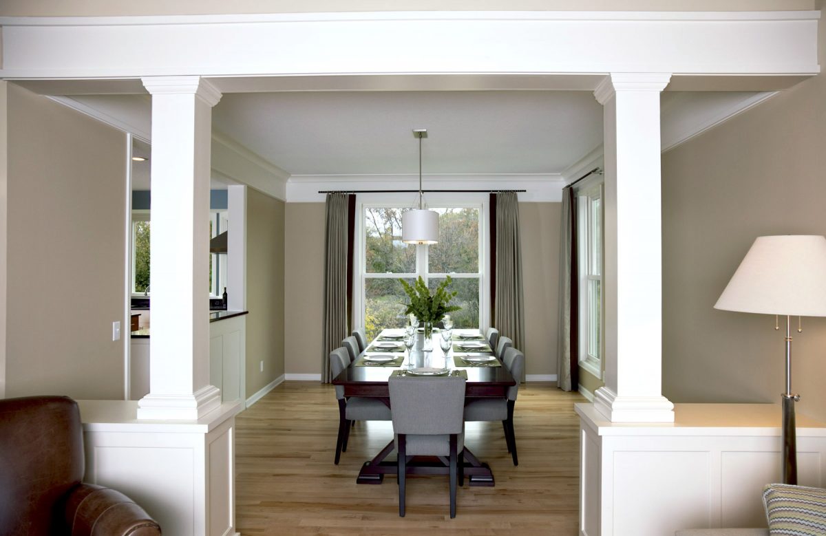 <p>The dining room was originally smaller and had builder-grade finishes. TreHus bumped out the back of the room to make it more spacious, and added new custom-built cabinets and pillars. The dining is now open to the kitchen as well.</p>
