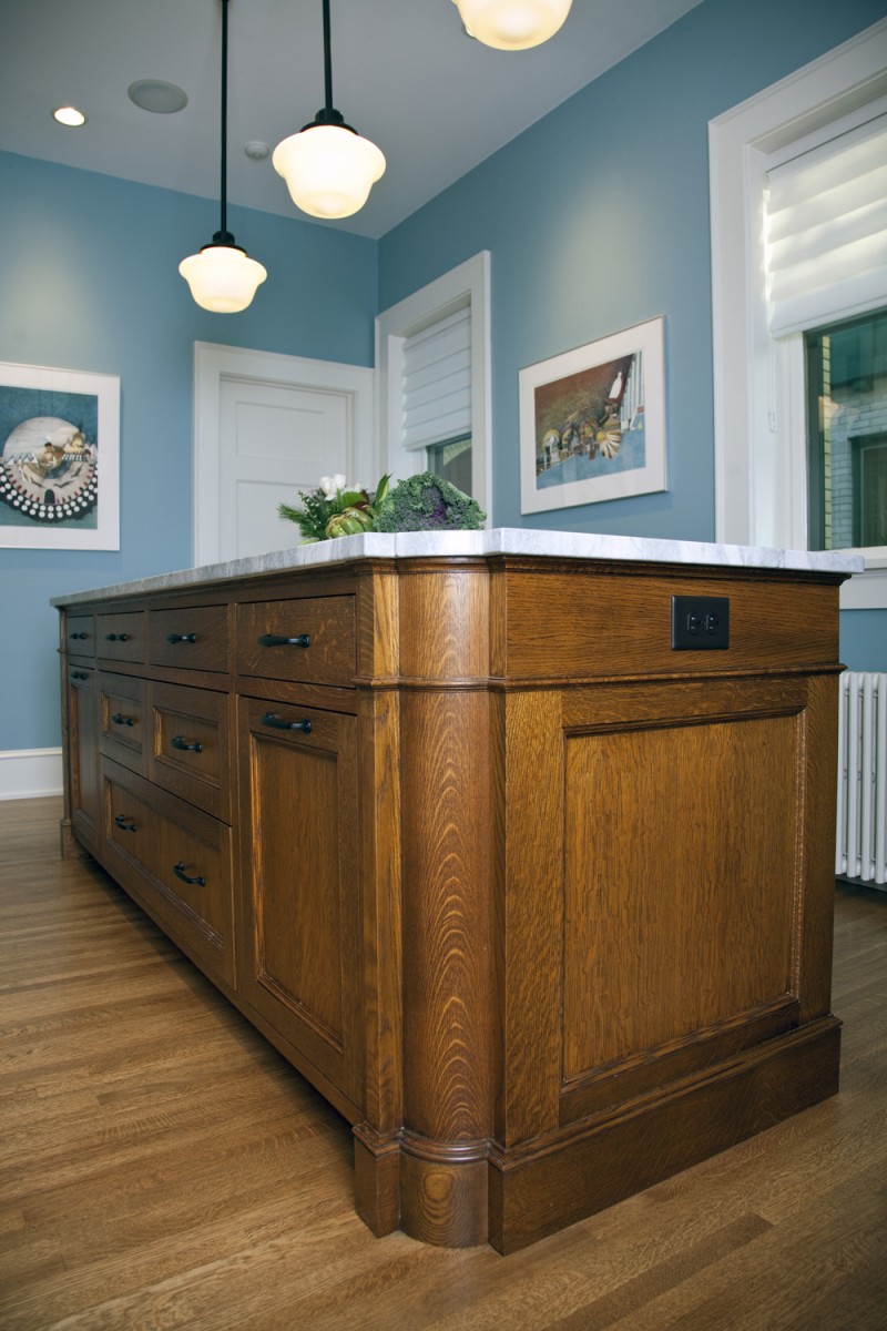 <p>The island and floor are both quartersawn oak, matching the buffet and floors in the rest of this grand old home. The rounded side of the island adds visual interest and imitates the buffet in the dining room.</p>
