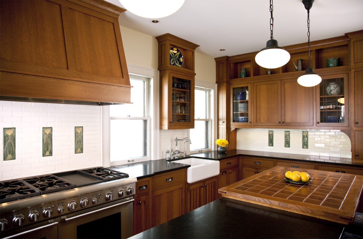<p>The owners of this 1919 craftsman home in Tangletown desired to infuse their kitchen with the old-world character that they loved in the rest of their home. Taking their cue from an antique Stickley island they had previously purchased, our design team created a remodeled kitchen with custom quartersawn oak cabinets, custom-designed, handmade accent tiles, and a farmhouse sink.</p>
