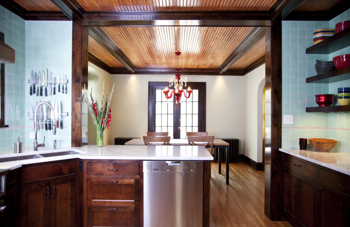 <p>Designed for a professional chef, this kitchen is as practical as it is beautiful. Open storage is utilized, providing easy access to dishes and cookware and to expedite the preparation of the latest delicacies. The design incorporates materials and details inspired by the clients’ childhood homes and their fondness for vintage diners. Beams and beadboard on the ceiling tie the kitchen and dining room together and rich textures like carrera marble countertops and handcrafted mint green tile add a higher level of refinement and a little spice to this kitchen.</p>
