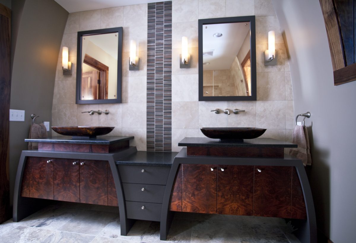 <p>The owners of this eclectic home desired a bright, modern master bathroom that tied into the unique character of their home. Our designers answered the call by creating curved walls and vanities to match the home’s curved exterior walls, and by using rich textures like burled walnut and painted sinks to match the home’s faux-painted interior. The result is a strikingly unique bathroom with a flavor that jives with the rest of their funky and eclectic home.</p>
