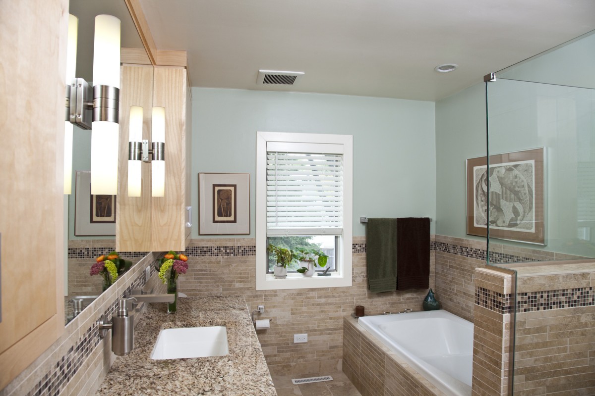 <p>Colors of nature line the inside of this bathroom remodel, bringing the outdoors in. Two different stain colors give this bath vanity a contemporary feel while showcasing the natural wood. The decorative tile band meanders its way through out the space giving it a sense of cohesion and playfulness.</p>
