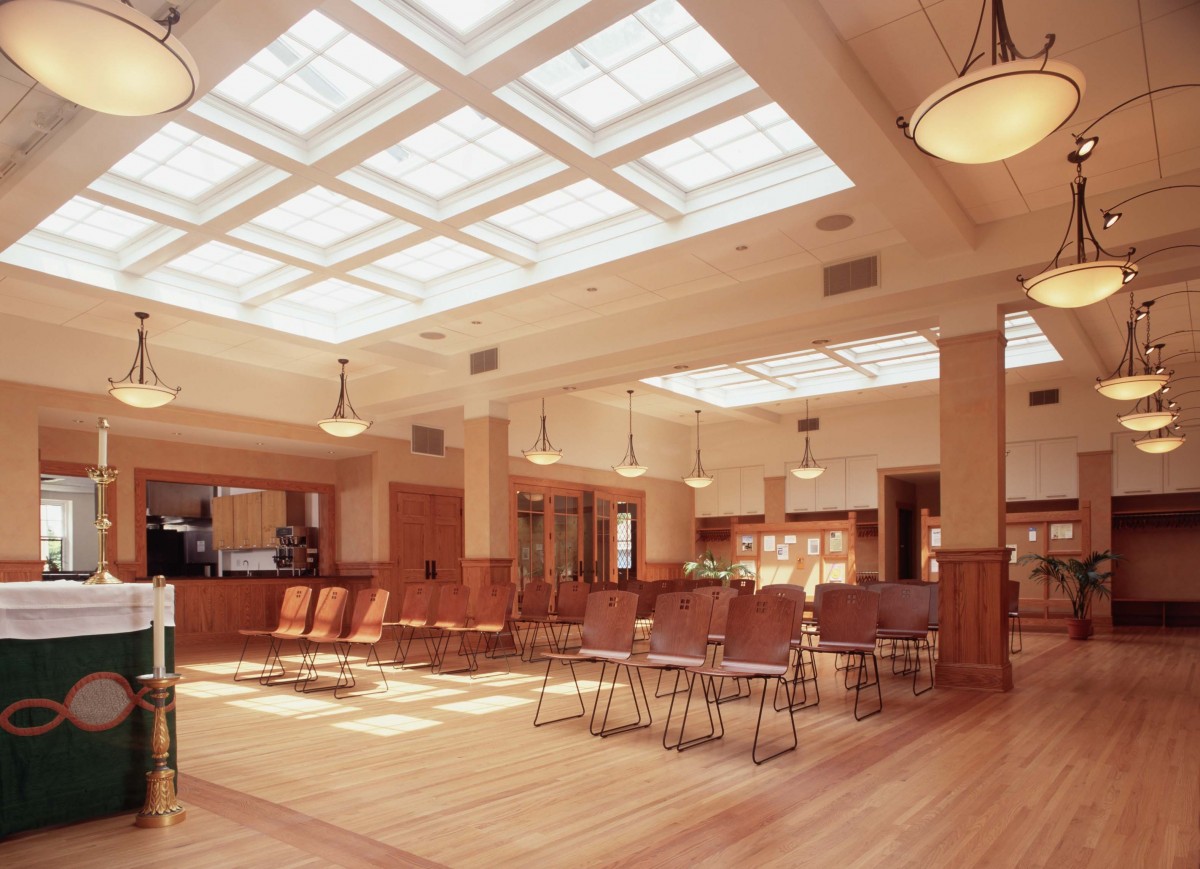 <p>Here is a look at the fellowship hall.  The ceiling is a network of windows that flood the space with light – the windows are original but had been covered up  by a suspended ceiling.</p>
