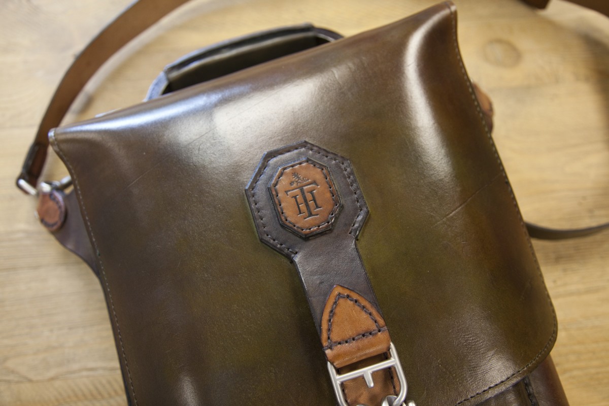 <p>A closeup of the front of the bag.  Again, they were able to re-create our logo.  Each piece of leather is hand-cut and hand-stitched together.</p>
