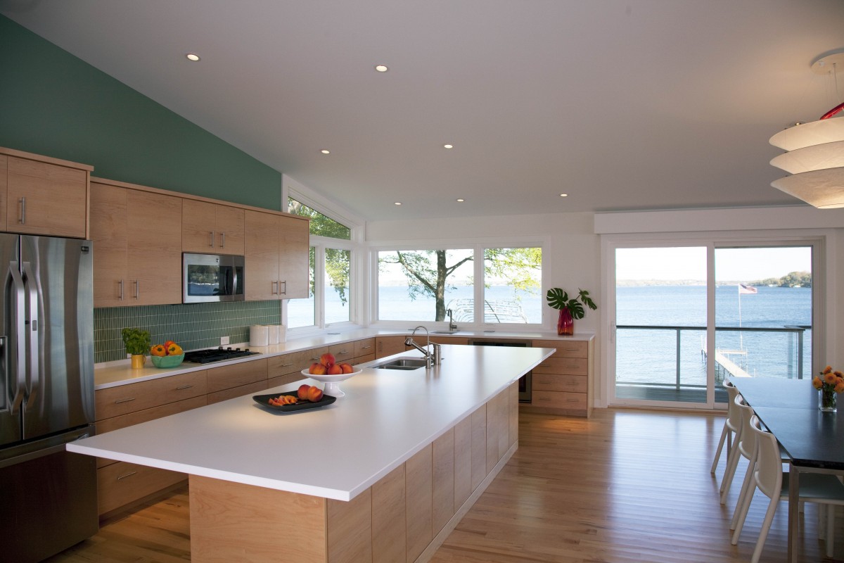 <p>This Lake Minnetonka kitchen was designed to take full advantage of the beautiful view. The aqua wall, matching backsplash tile and light maple cabinetry echo the home’s tranquil lakeshore feeling.</p>
