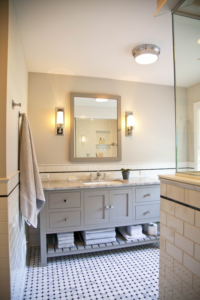 <p>A fresh approach to classic style completely transformed this master bathroom. Soft gray walls, white subway tile and marble flooring exemplify the feeling of casual luxury. The large medicine cabinet and generous vanity with open shelf provide ample storage space.</p>
