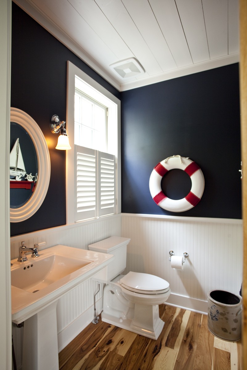 <p>This powder room is located just off the mudroom adjacent to the kitchen. Themes from the rest of the first floor are present here as well: beadboard on the walls is reminiscent of accents on the kitchen cabinets, and the same tongue-and-groove boards that adorn the ceilings on the rest of the first floor are here as well.</p>
