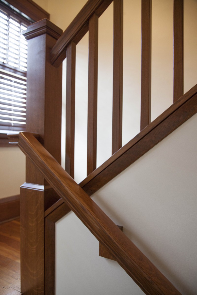 <p>The existing stairway had two major issues: the large wall limited the size of furniture the clients could bring upstairs, and the ceiling height was too low for tall members of the family. Problems were solved by raising the ceiling and opening the wall to add a finely-crafted banister.</p>

