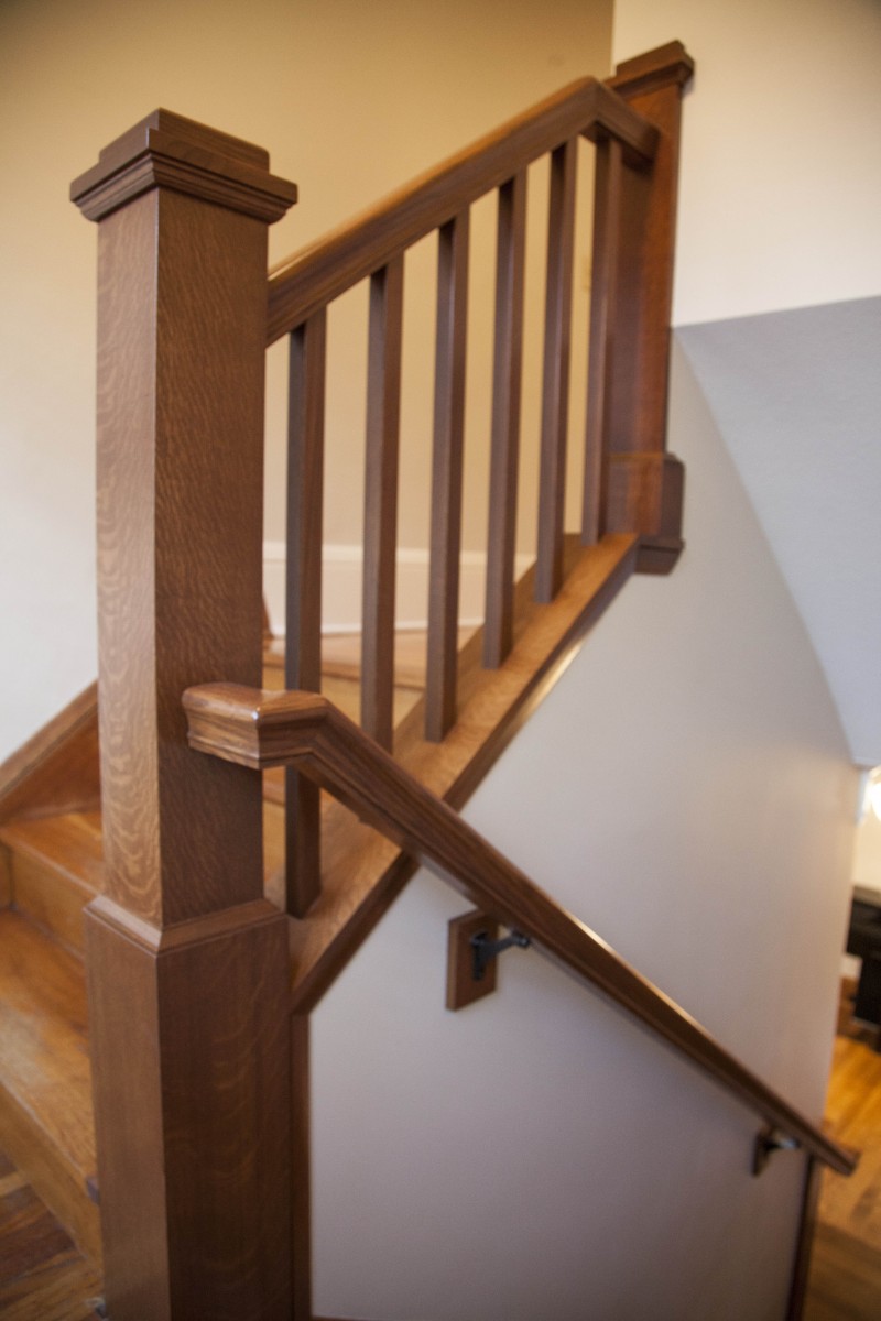 <p>The existing stairway had two major issues: the large wall limited the size of furniture the clients could bring upstairs, and the ceiling height was too low for tall members of the family. Problems were solved by raising the ceiling and opening the wall to add a finely-crafted banister.</p>
