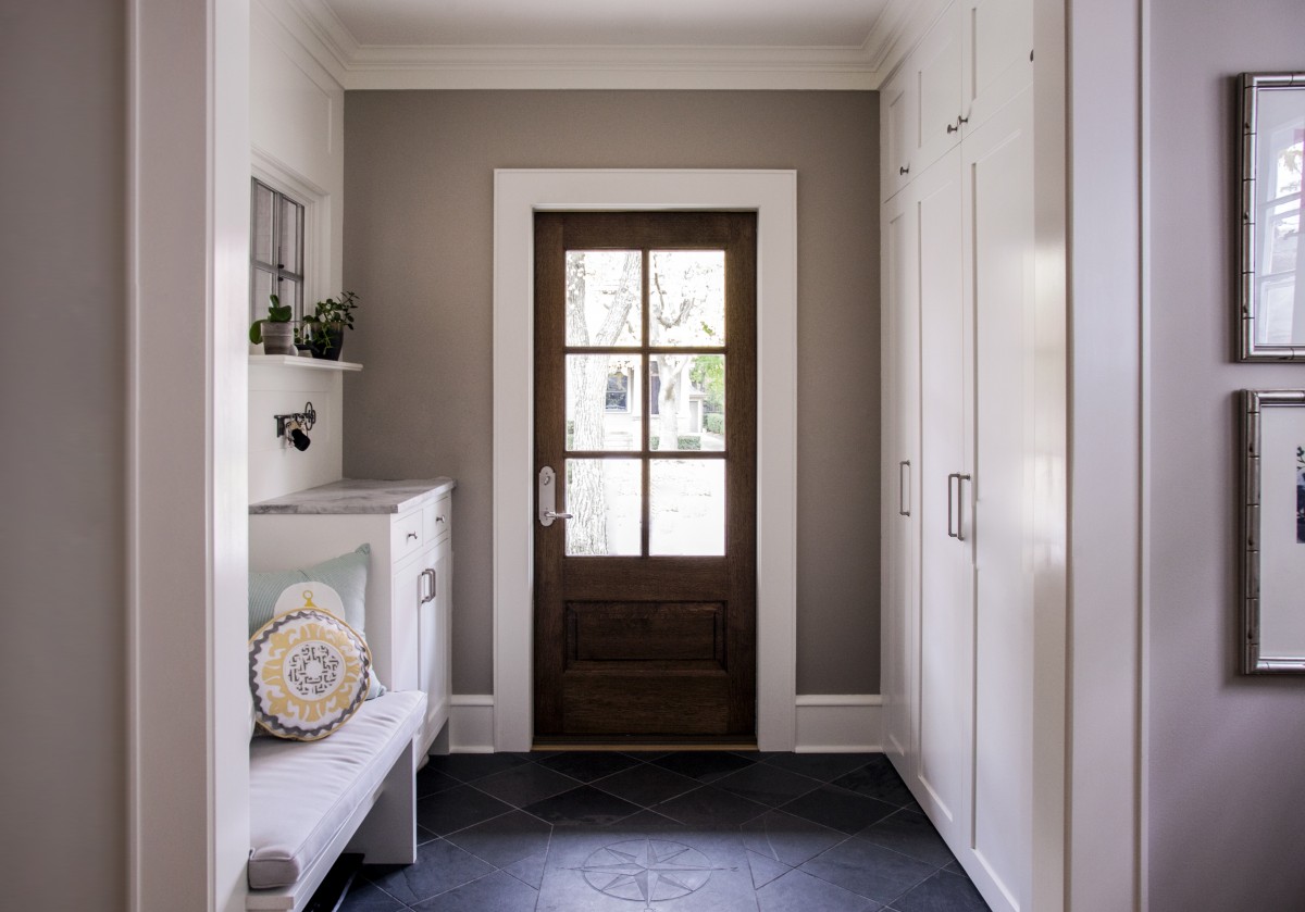 <p>The entryway was opened up to create a more welcoming and spacious foyer. A built in bench and floor-to-ceiling cabinets create storage.</p>
