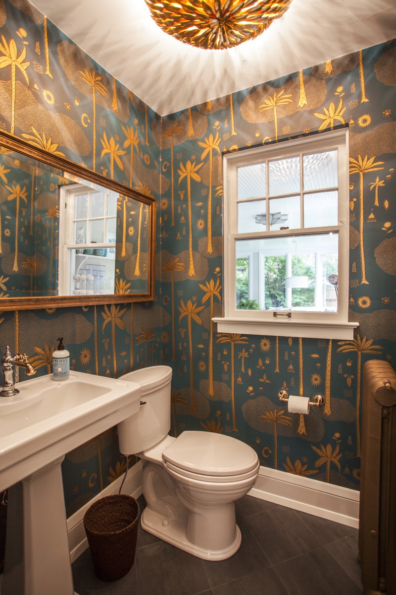 <p>A new pedestal sink and toilet give this stylish powder room a much deserved upgrade. New porcelain tiles throughout the bathroom replaced the old cork floors.</p>

