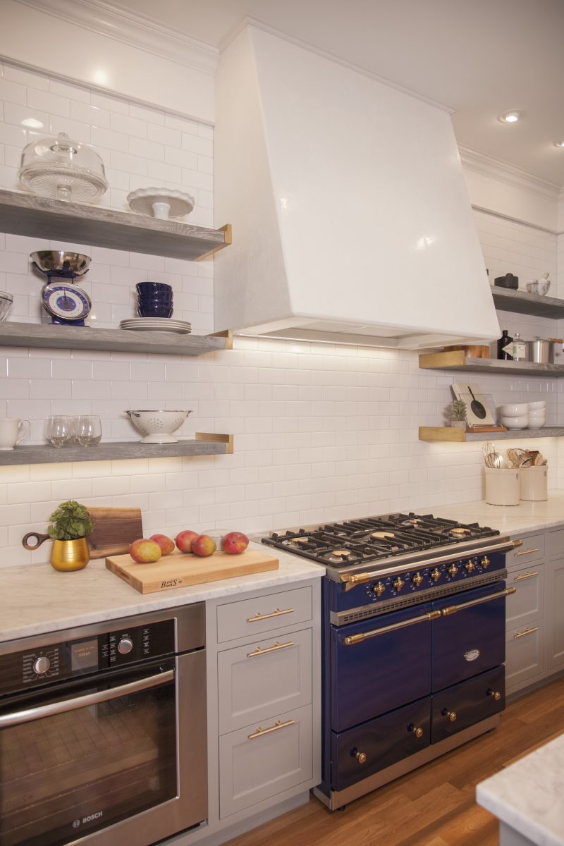 <p>Open cerused oak shelving and white subway tiles give the kitchen an open feel, while a handmade venetian plaster hood and custom brass shelf ends add an old-world feel to the space and accentuate the superb Lacanche stove.</p>
