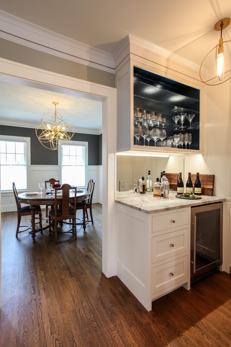 <p>The owners wanted a bar to allow the mixologist in the family a space to prepare cocktails with homemade bitters. The lights and hardware connected the contemporary shape of the dining room chandelier and the globes in the kitchen.</p>
<p><iframe loading="lazy" src="https://my.matterport.com/show/?m=QZAzja3mfVH&amp;brand=0" width="853" height="480" frameborder="0" allowfullscreen="allowfullscreen"></iframe></p>

