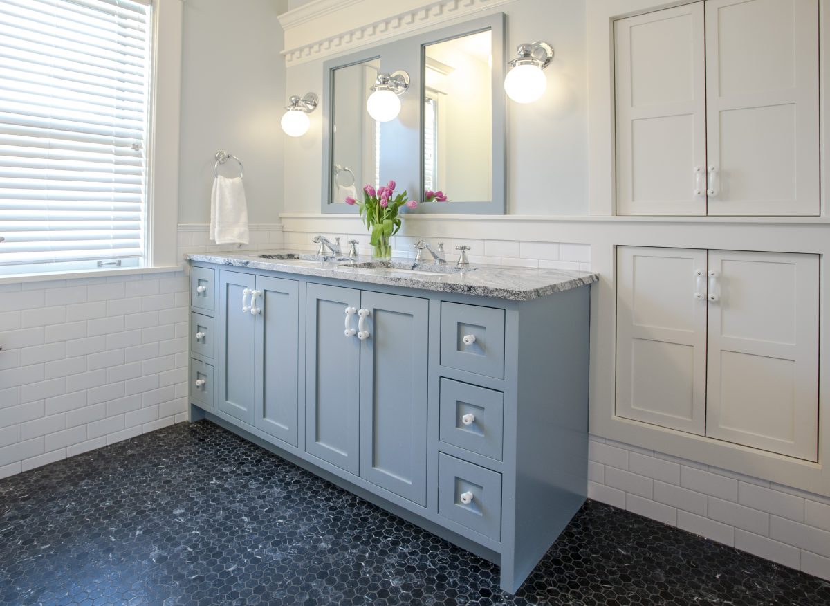 <p>The layout in the second-floor bathroom was changed to better accommodate the toilet, tub, and shower. A new vanity was added for more storage and kid delineated space. The crown trim along the vanity wall was part of the existing built in.</p>

